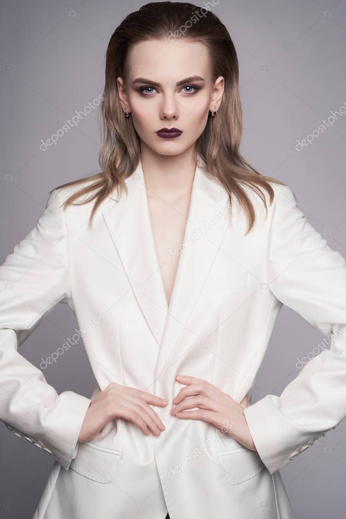 Elegant woman in white jacket