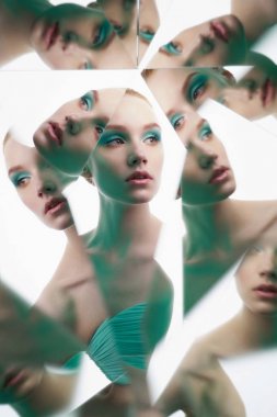 young beautiful woman with bright colorfull makeup isolated on w