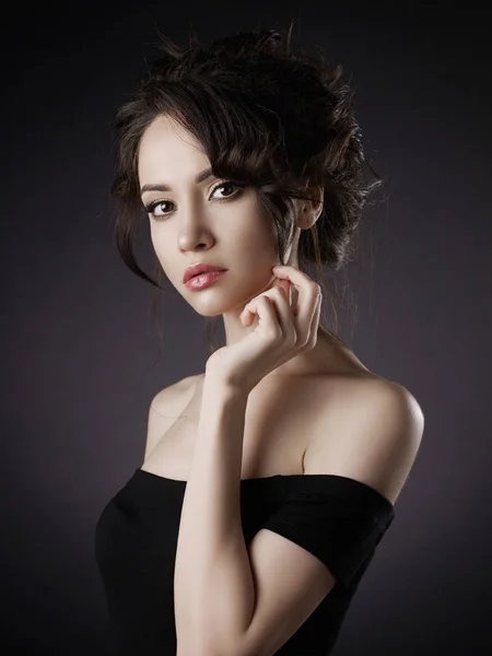 Beautiful woman with elegant hairstyle on black background — Stock Photo, Image