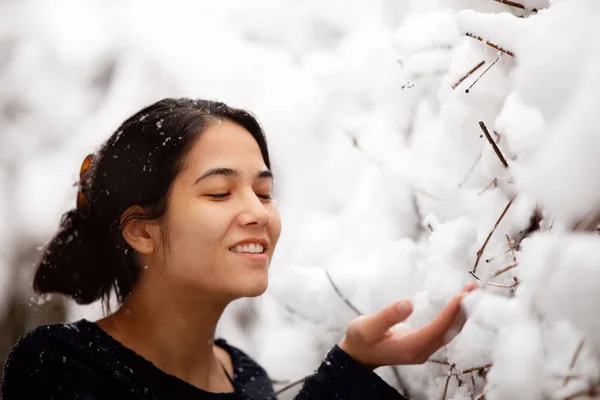 Teen flicka utomhus armar utsträckta njuter snöfall på vintern — Stockfoto