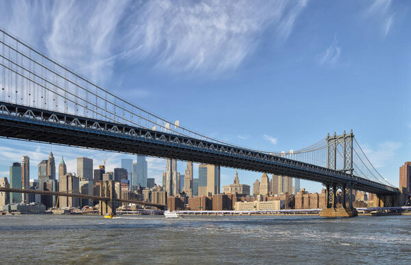 View of the Manhattan Bridge against a Manhattan skyline.