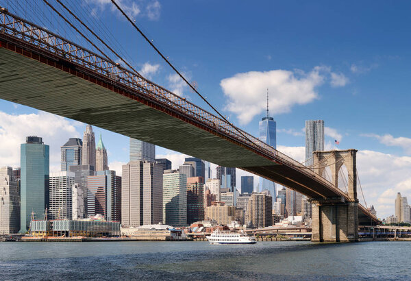 Lower Manhattan with Brooklyn Bridge at sunny day.
