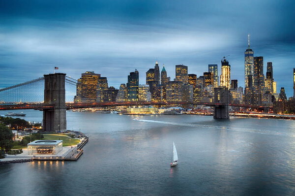 Twilight view of Lower Manhattan with Brooklyn Bridge.