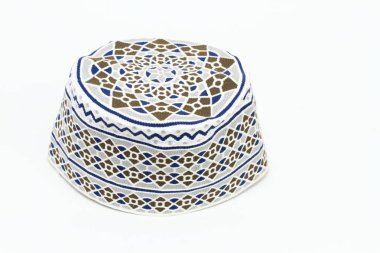 Umman'da giyilen geleneksel Müslüman şapkası. Umman şapkası beyaz arka planda kumma olarak adlandırılır.  