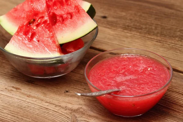 Water melon face mask for natural beauty. Edible cosmetic from fresh melon on wooden board