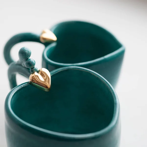 Two turquoise cups for tea or coffee on the white table — Stock Photo, Image