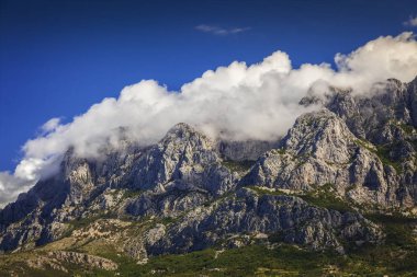 Clouds on the top of the Biokovo mountain range, Croatia. clipart