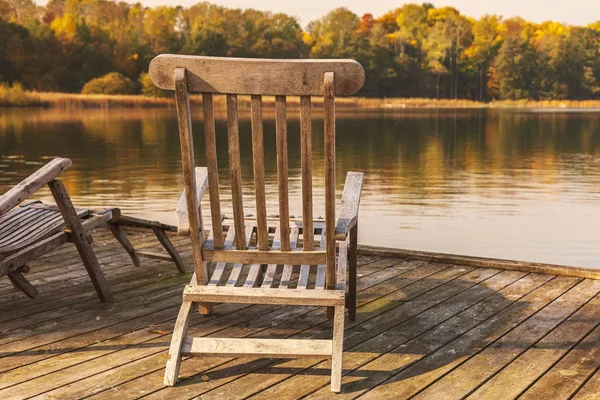 Wooden sunloungers by lake in autumn. — Stock Image Wooden Sunloungers Lake Autumn Stock Image