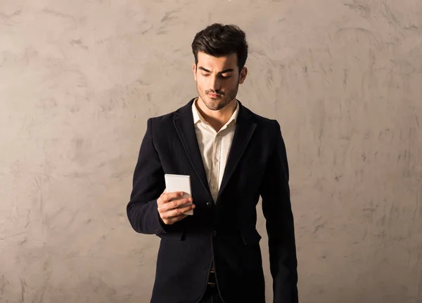 A serious young businessman using a smartphone — Stock Photo, Image