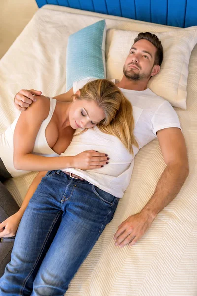 Young couple lying on the bed — Stock Photo, Image