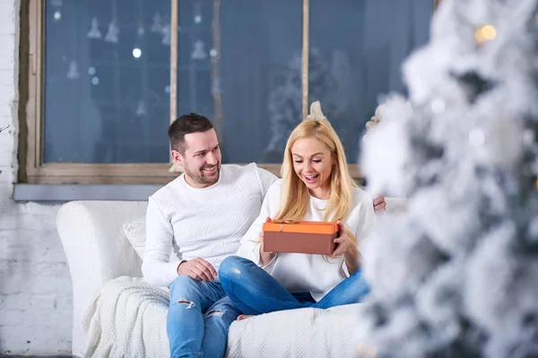 Paar op een bank geven van cadeautjes — Stockfoto
