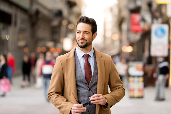 An elegant man walking on the streets