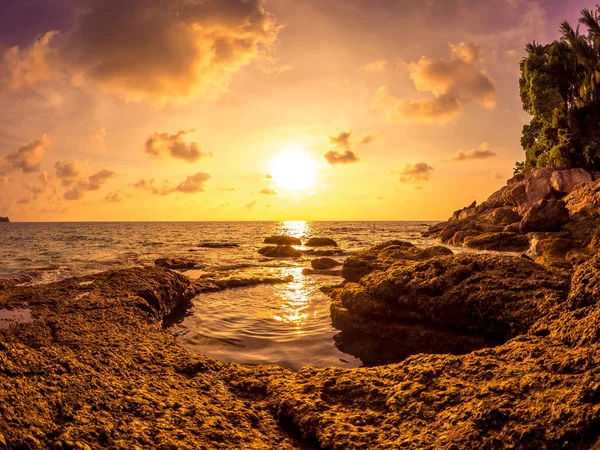 Sunset on the rocks of Surin beach, Phuket, Thailand — Stock Photo, Image