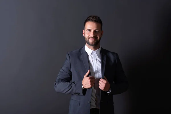 Un hombre de negocios sonriente parado en un estudio — Foto de Stock