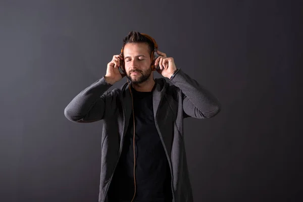 A handsome man listening to music and enjoying it — Stock Photo, Image