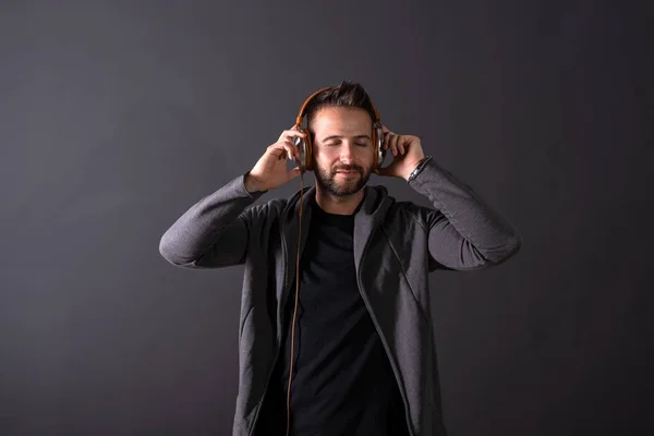 A handsome man listening to music and enjoying it — Stock Photo, Image