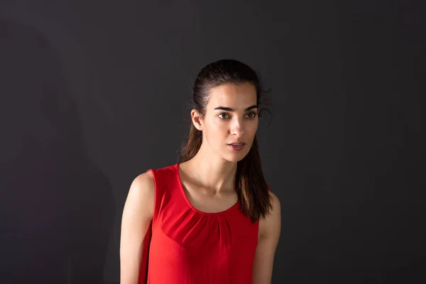 A serious young woman standing in the studio — Stock Photo, Image