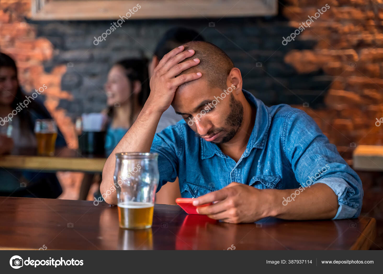 A lonely man sitting at the bar — Stock Photo © Spectral #387937114
