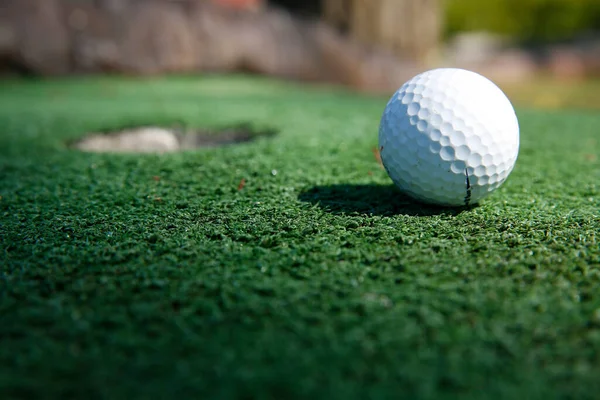 Mini golf white ball on artificial grass