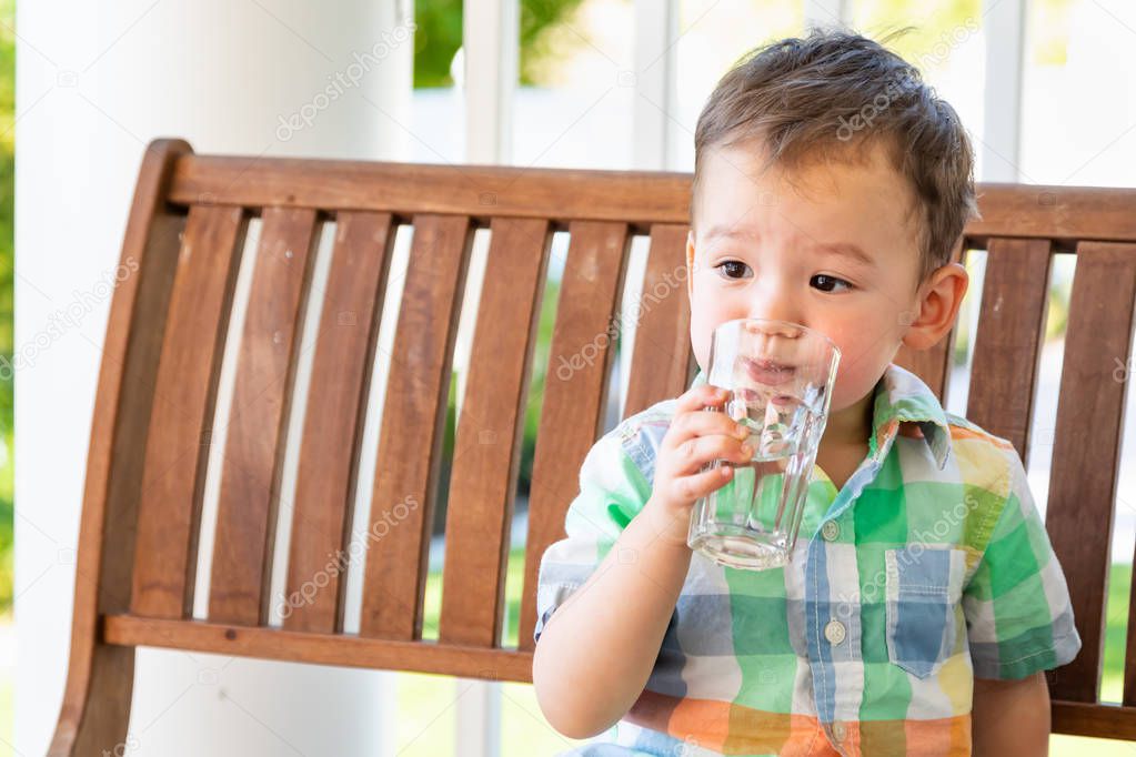 Mixed Race Chinese and Caucasian Boy Enjoying A Glass Of Water