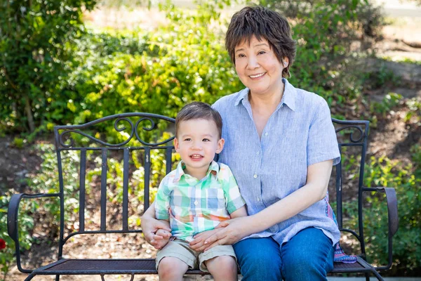 Chinese Grandmother Mixed Race Child Sit Bench Outdoors — Stock Photo, Image