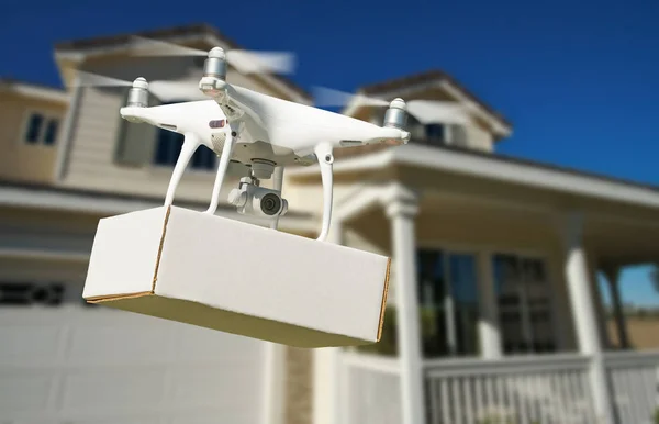 Unmanned Aircraft System (UAV) Quadcopter Drone Delivering Package At House.