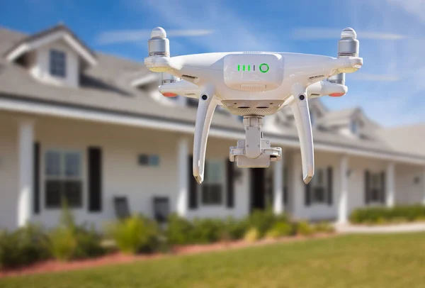 Back of Unmanned Aircraft System (UAV) Quadcopter Drone Flying In Front of House.