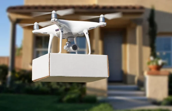 Unmanned Aircraft System (UAV) Quadcopter Drone Delivering Package At House.