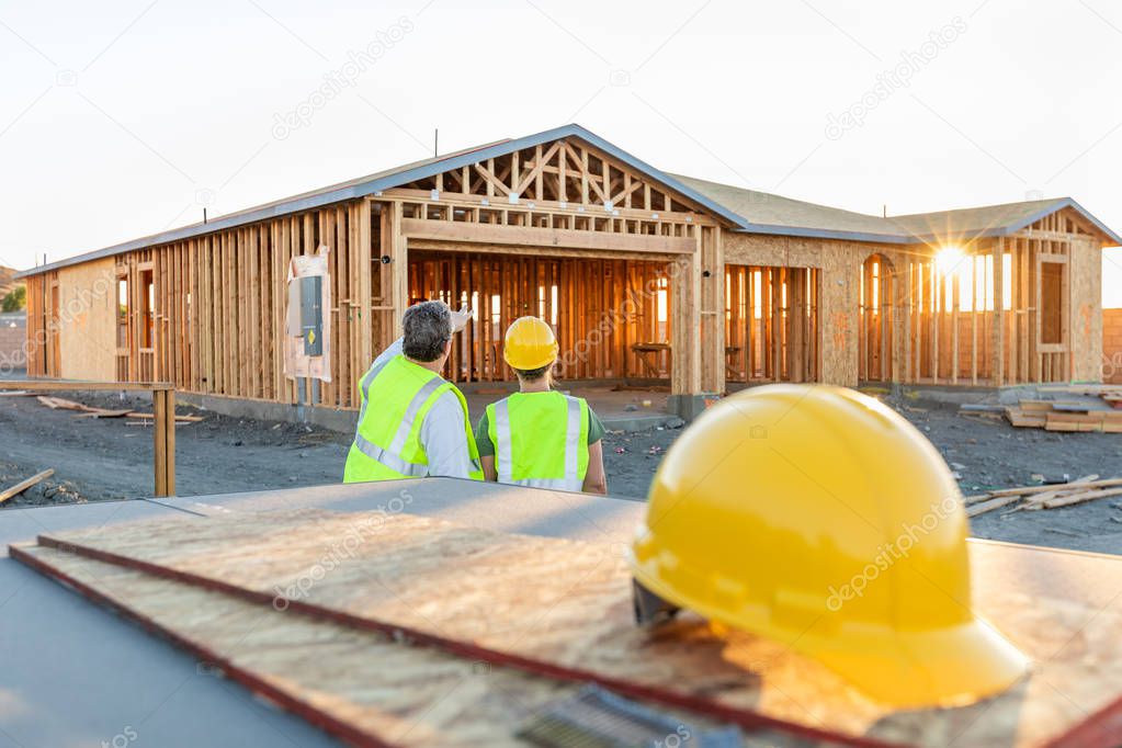 Male and Female Construction Workers at New Home Site.