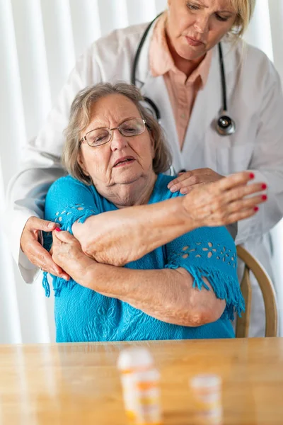 Female Doctor Helping Senior Adult Woman Arm Exercises — Stock Photo, Image