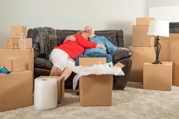 Affectionate Tired Senior Adult Couple Resting Couch Surrounded Moving Boxes — Stock Photo, Image