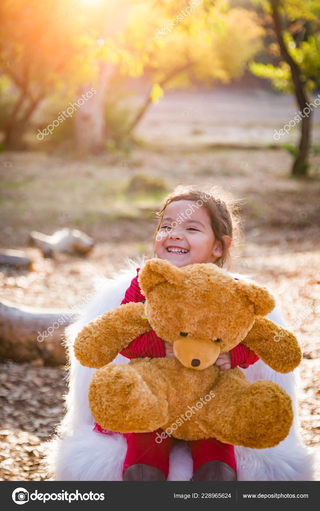 baby hugging teddy bear