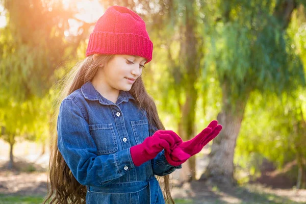 Cute Mixed Race Young Girl Wearing Red Knit Cap Putting — Stock Photo, Image