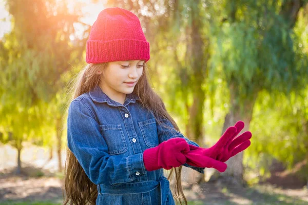 Cute Mixed Race Young Girl Wearing Red Knit Cap Putting — Stock Photo, Image