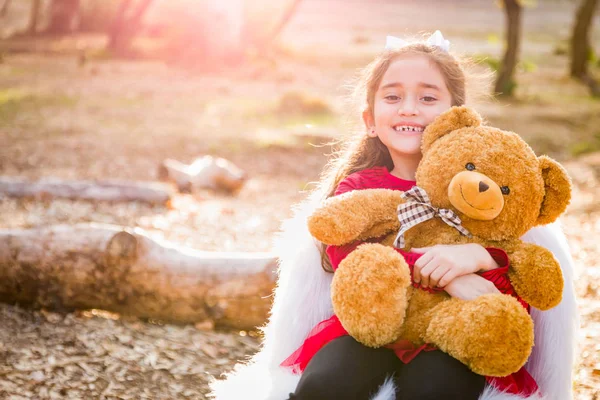 Cute Young Mixed Race Girl Hugging Teddy Bear Outdoors — Stock Photo, Image