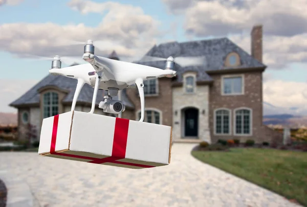 Unmanned Aircraft System (UAV) Quadcopter Drone Delivering Box With Red Ribbon To Home