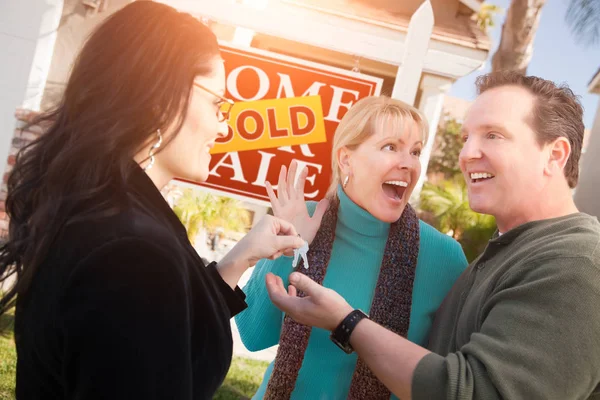 Hispanic Female Real Estate Agent Handing New House Keys Happy Stock Photo