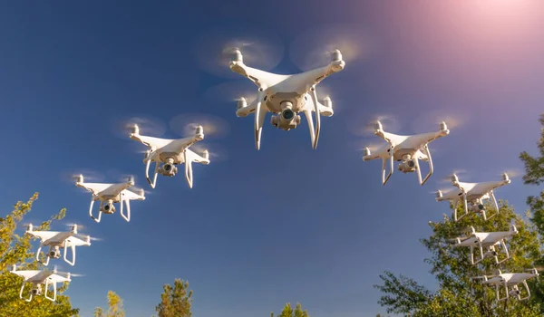 Dozens of Drones Swarm in the Clear Sky.