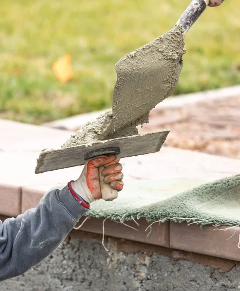 Construction Worker Placing Wet Cement On Platter For Tile Worke