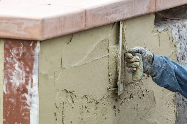 Azulejo trabajador aplicación de cemento con paleta en la construcción de la piscina Sit — Foto de Stock