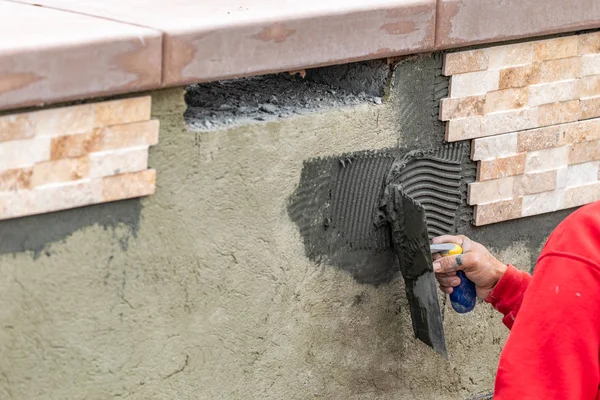 Worker Installing Wall Tile Cement with Trowel and Tile at Const — Stock Photo, Image