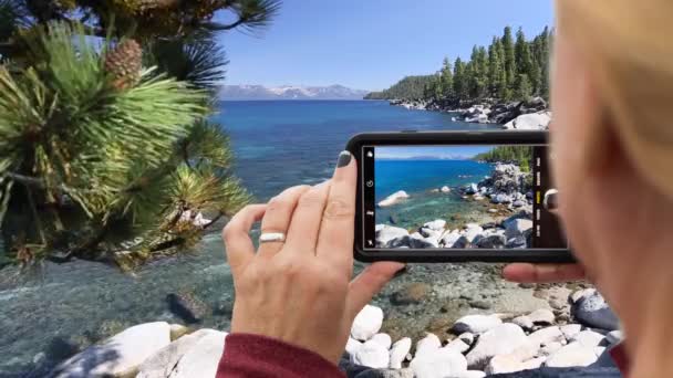 Looping Cinemagraph Woman Filming Lake Shore Landscape Smart Phone — Stock Video