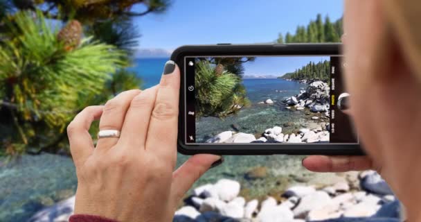Looping Cinemagraph Woman Filming Lake Shore Landscape Smart Phone — Stock Video