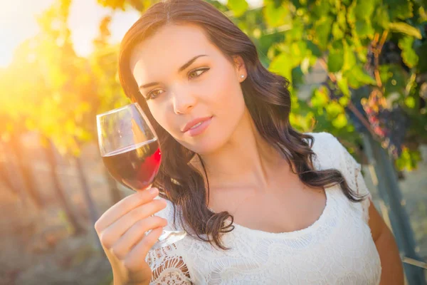 Красивая молодая взрослая женщина наслаждается бокалом вина дегустации в винограднике — стоковое фото