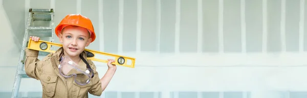 Cute Young Boy Dressed As Contractor Holding Level Against Dywall Banner Background with Ladder. — Stock Photo, Image