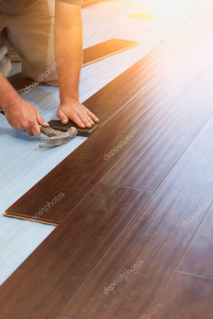 Man Installing New Laminate Wood Flooring