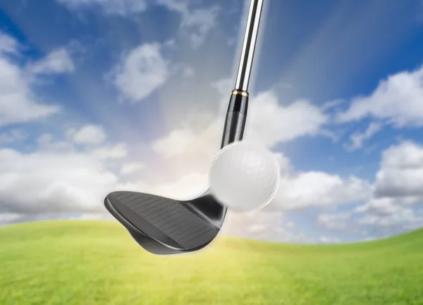 Black Golf Club Wedge Iron Hitting Golf Ball Against Grass and Blue Sky Background — Stock Photo, Image