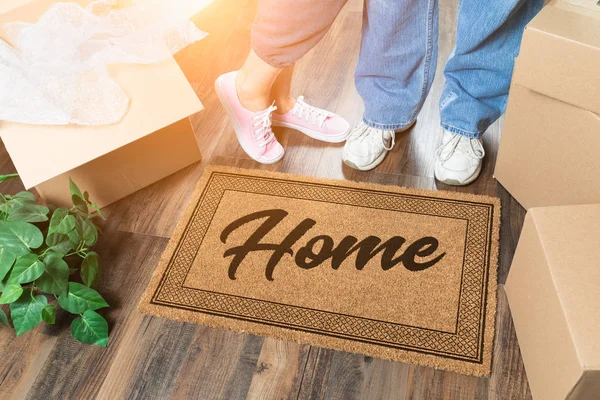 Man and Woman Unpacking Near Home Welcome Mat, Moving Boxes and Plant — Stock Photo, Image