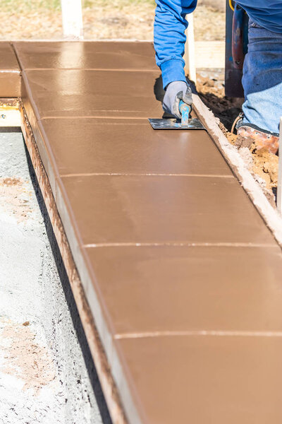 Строитель с помощью нержавеющей стали Edger на мокрой цементной формовки справиться вокруг нового бассейна