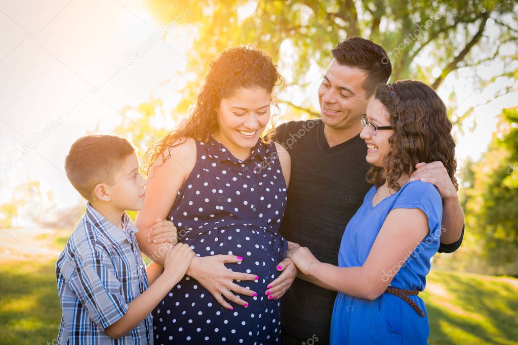 Hispanic Pregnant Family Portrait Outdoors